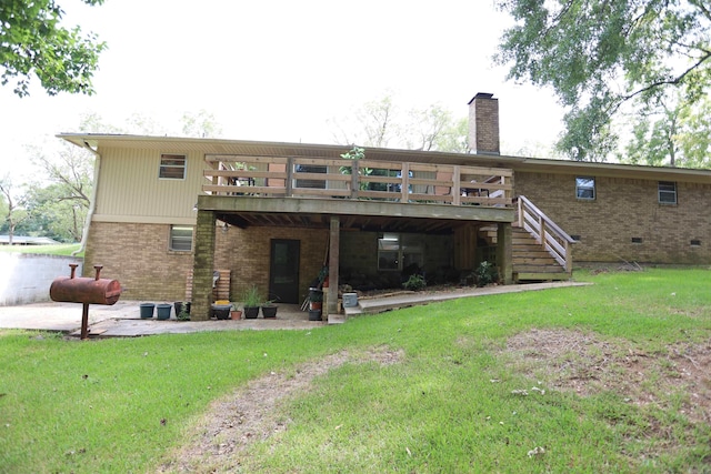 rear view of property featuring a lawn and a wooden deck