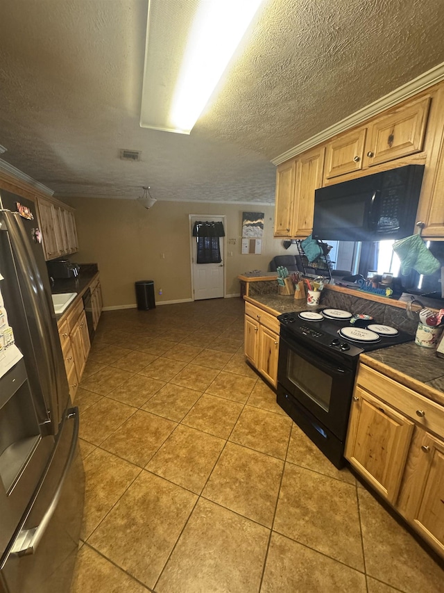 kitchen with light tile patterned flooring, a textured ceiling, and black appliances