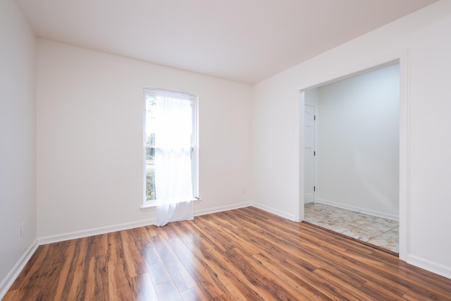 unfurnished room featuring dark wood-type flooring