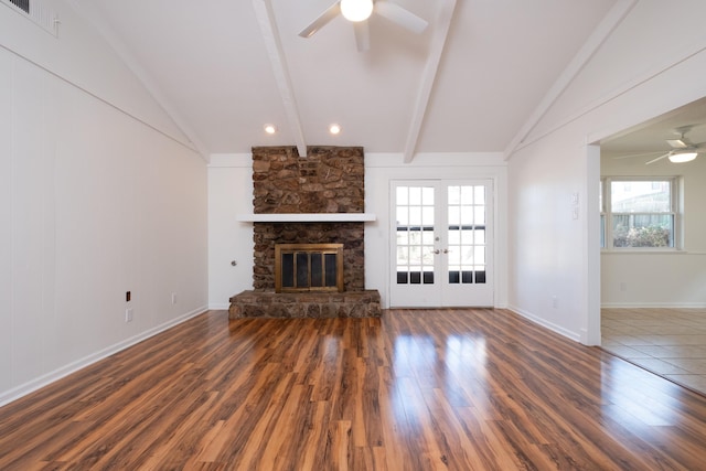 unfurnished living room with french doors, a fireplace, vaulted ceiling with beams, dark hardwood / wood-style floors, and ceiling fan