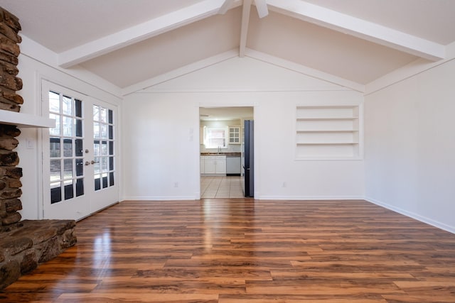 unfurnished living room with hardwood / wood-style floors, french doors, sink, built in features, and lofted ceiling with beams