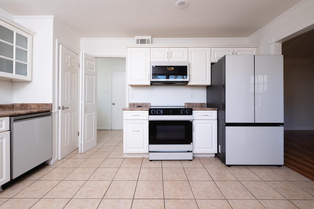 kitchen featuring white cabinetry, crown molding, appliances with stainless steel finishes, and a textured ceiling