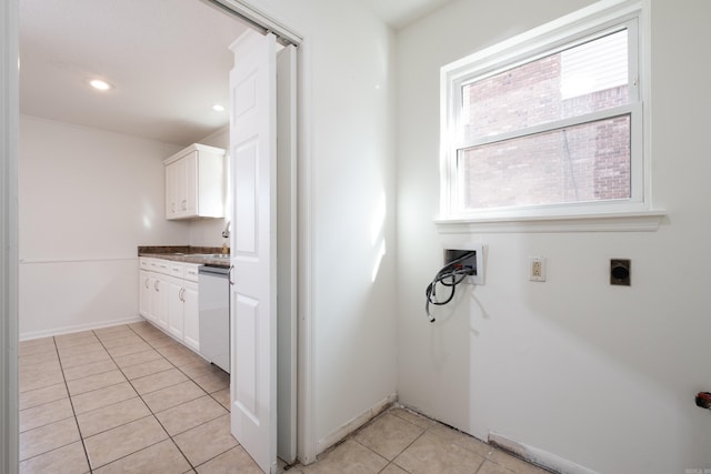 laundry area with hookup for an electric dryer, a healthy amount of sunlight, washer hookup, and light tile patterned floors