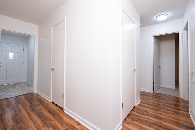 hall with dark hardwood / wood-style floors