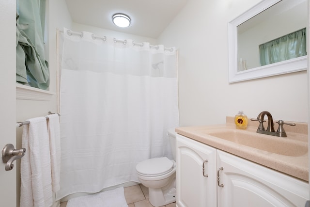 bathroom featuring toilet, vanity, and tile patterned flooring