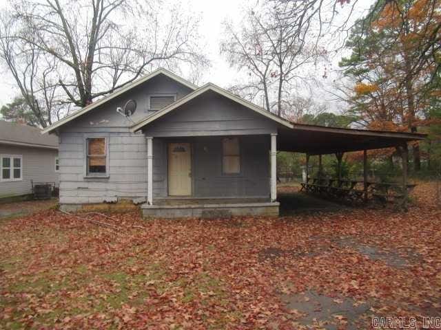 view of front of property with central air condition unit and a carport