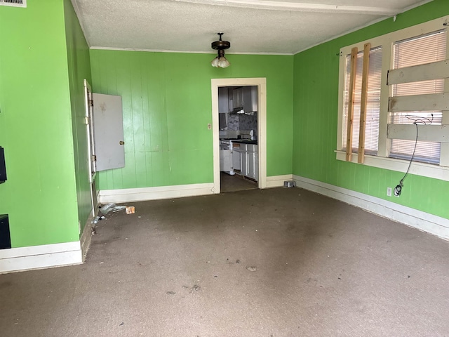 interior space with baseboards, visible vents, and a textured ceiling