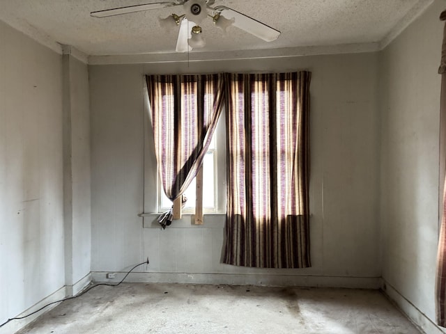 unfurnished room featuring a ceiling fan and a textured ceiling