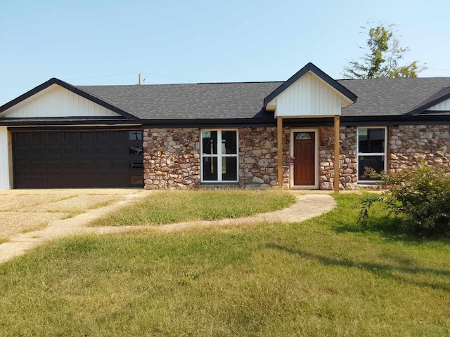 ranch-style house featuring a garage and a front yard