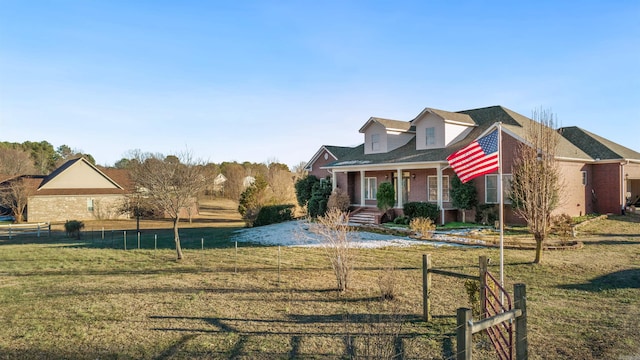 view of front of home featuring covered porch and a front yard