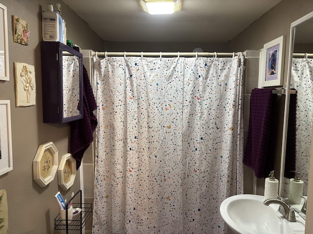 bathroom with sink and a shower with curtain