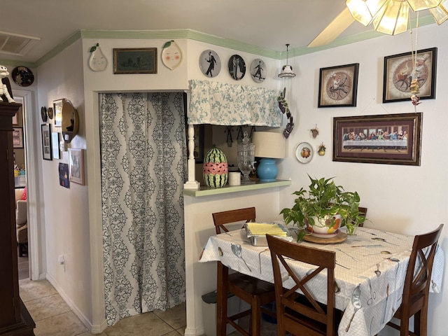 tiled dining area with ceiling fan