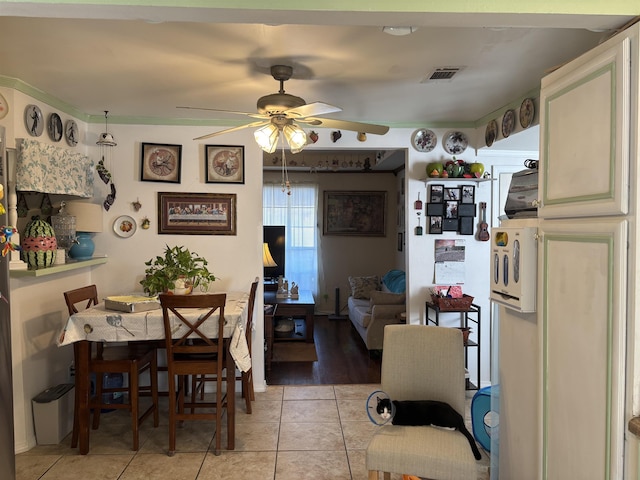 dining room with light tile patterned flooring and ceiling fan