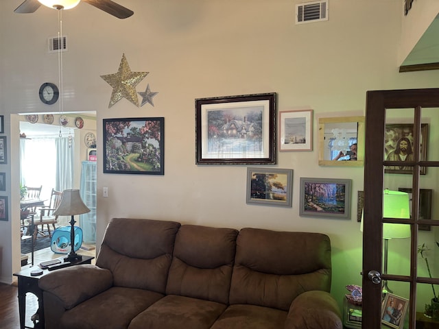 living room with ceiling fan and wood-type flooring