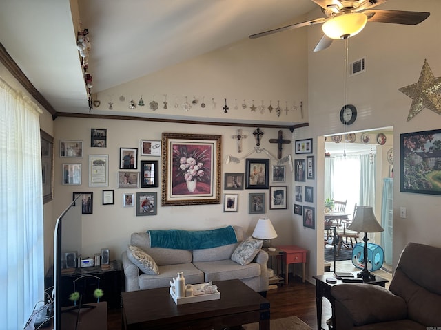 living room with vaulted ceiling, ceiling fan, ornamental molding, and dark wood-type flooring