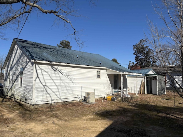 rear view of house with central AC unit