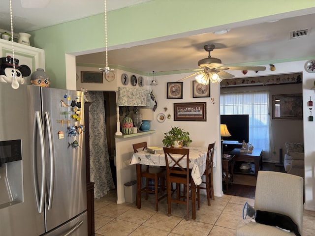 dining space featuring ceiling fan and light tile patterned flooring