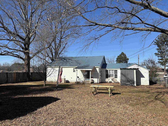 back of house with a lawn