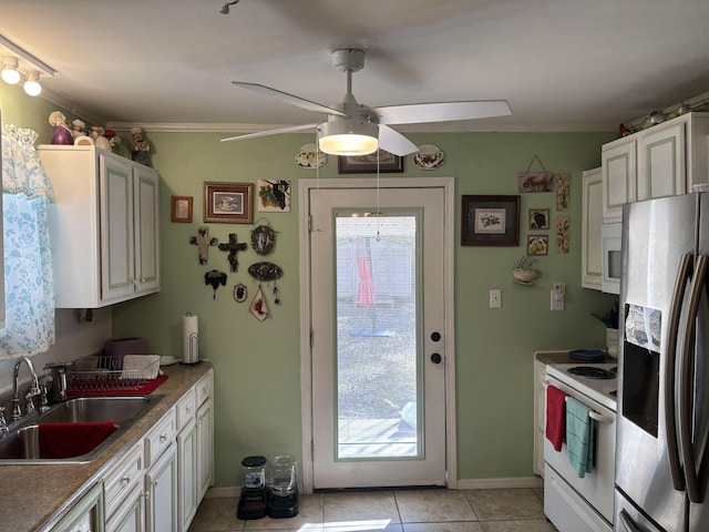 kitchen featuring stainless steel refrigerator with ice dispenser, white cabinetry, sink, electric range, and light tile patterned floors