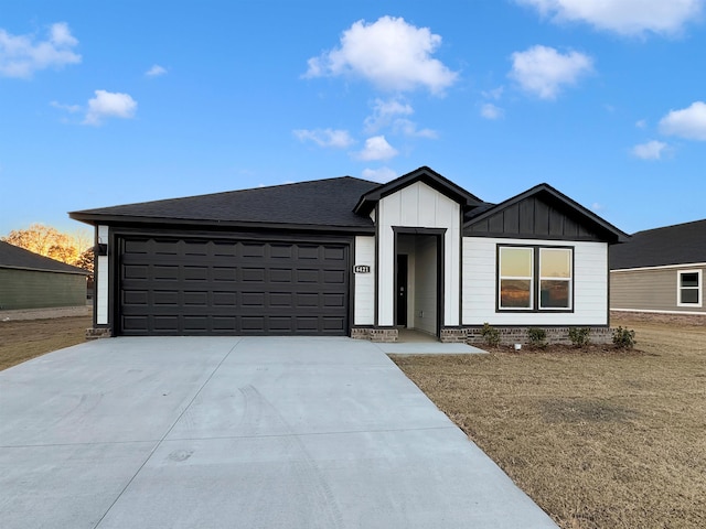 view of front of property with a garage and a front yard