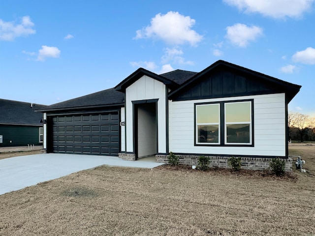 4352 Sloan Dr, Bryant, AR 72002 - view of front of property with concrete driveway, an attached garage, roof with shingles, and board and batten siding