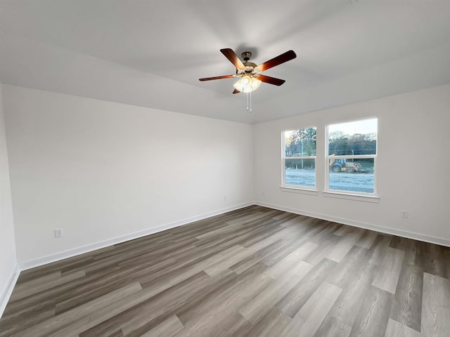 spare room with ceiling fan and wood-type flooring