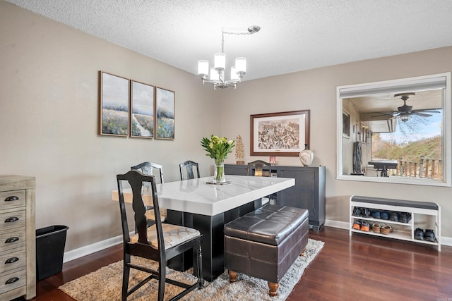 dining area with an inviting chandelier, a textured ceiling, and dark hardwood / wood-style flooring