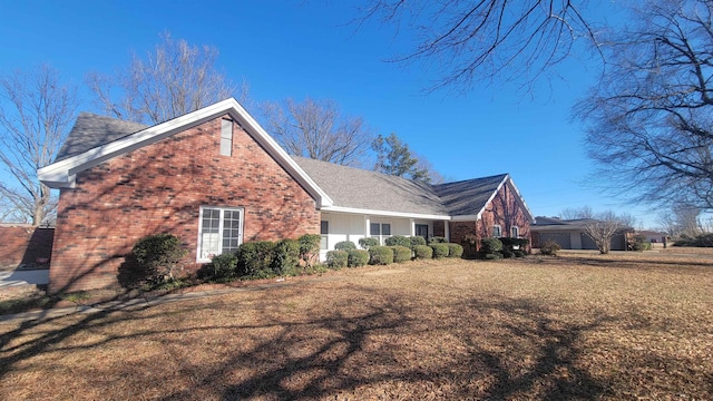 view of property exterior featuring a garage and a lawn