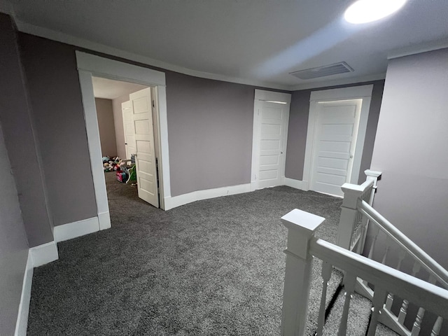 interior space featuring dark carpet