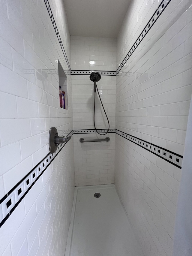 bathroom with a tile shower