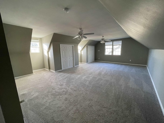 bonus room featuring carpet floors, plenty of natural light, a textured ceiling, and lofted ceiling