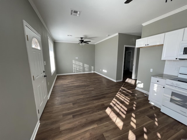 kitchen featuring white electric range oven, white cabinetry, dark hardwood / wood-style flooring, tasteful backsplash, and ceiling fan