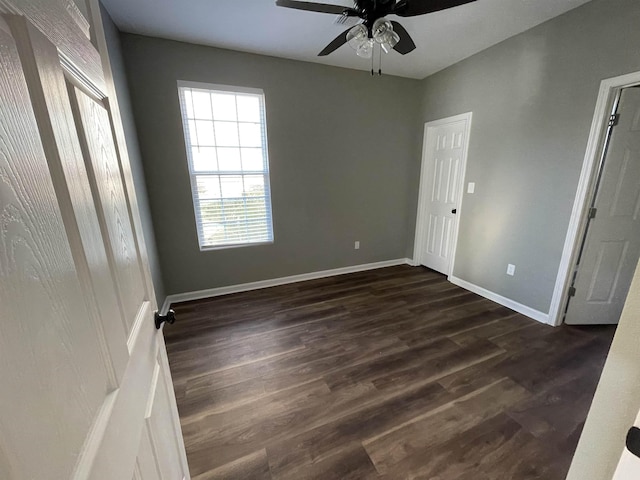 spare room with ceiling fan and dark wood-type flooring