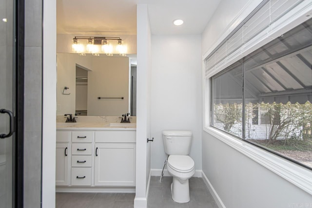 bathroom featuring vanity, tile patterned floors, and toilet