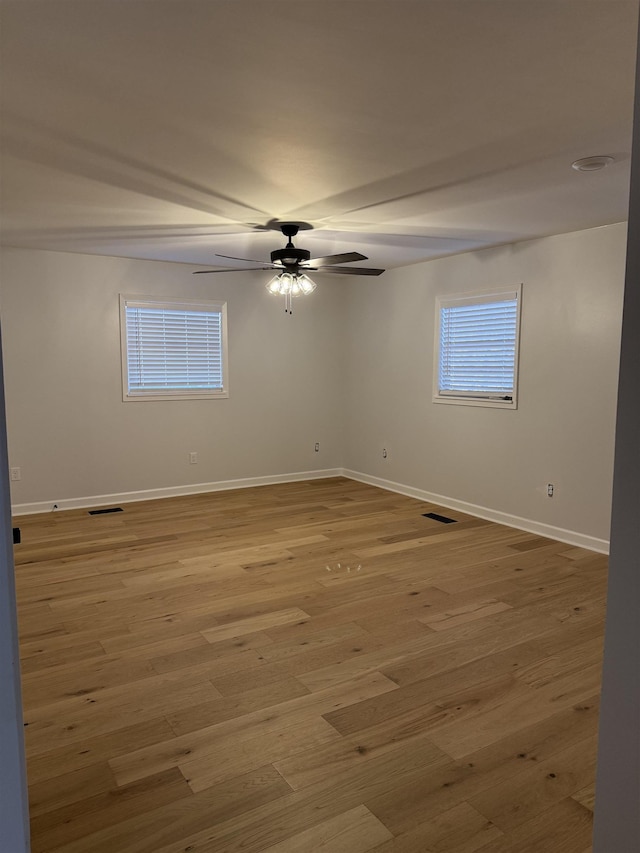 unfurnished room with ceiling fan and light wood-type flooring