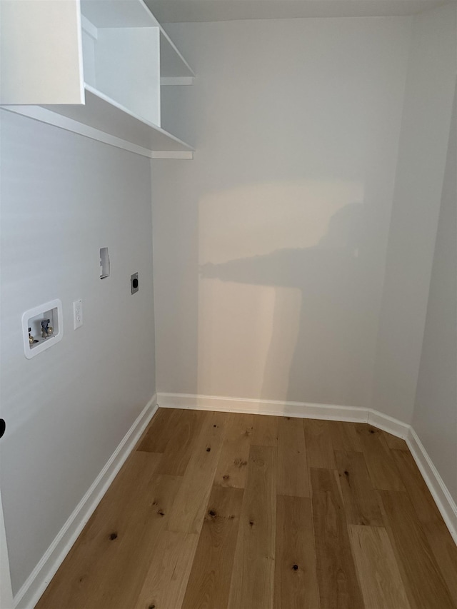 laundry room featuring hookup for a washing machine, electric dryer hookup, and light hardwood / wood-style flooring