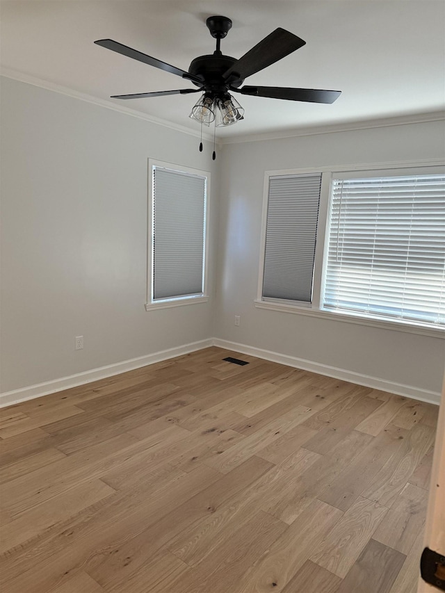 unfurnished room with crown molding, ceiling fan, and light wood-type flooring