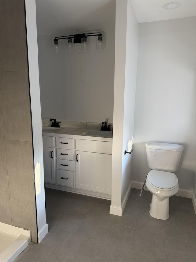 bathroom with tile patterned flooring, vanity, a shower, and toilet