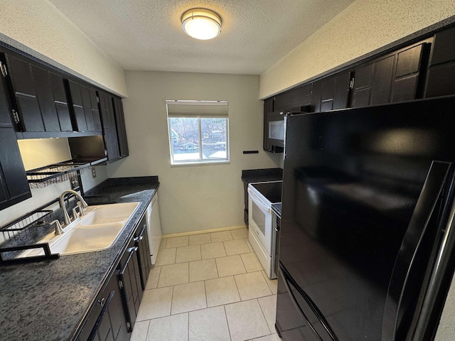 kitchen featuring sink, a textured ceiling, light tile patterned floors, and black appliances