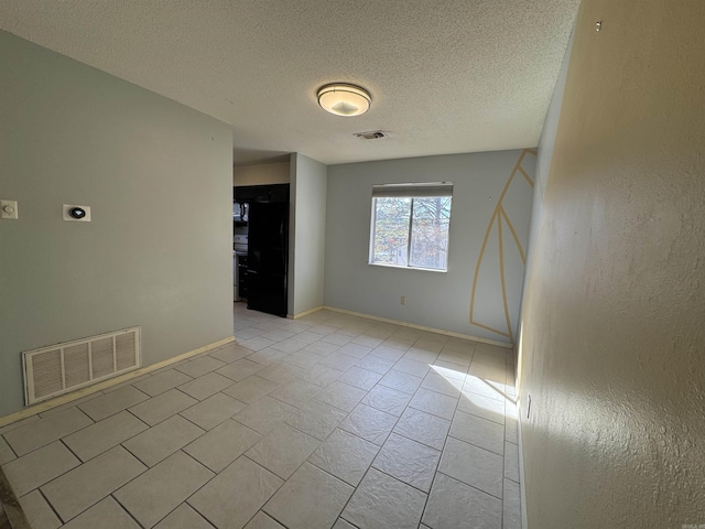 empty room featuring a textured ceiling