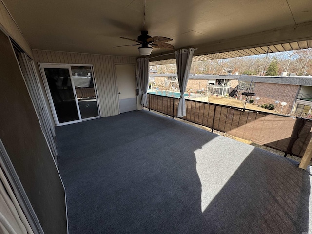 view of patio / terrace with ceiling fan and a balcony