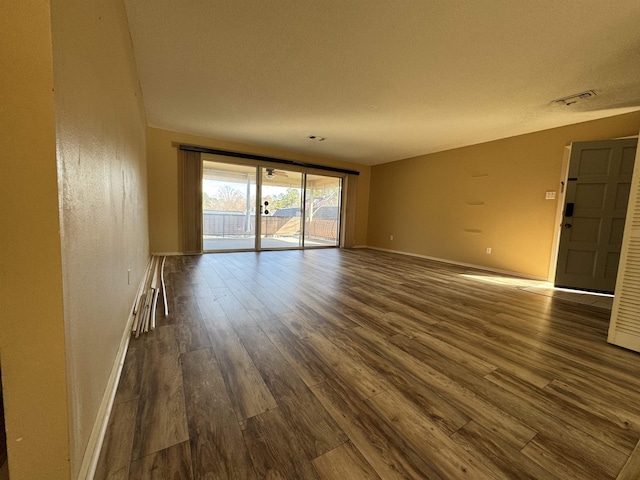 unfurnished room featuring dark wood-type flooring