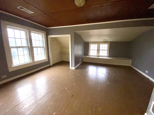 bonus room with wood-type flooring and vaulted ceiling