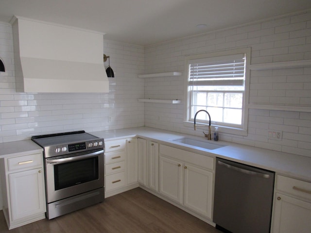 kitchen with white cabinetry, sink, backsplash, and appliances with stainless steel finishes