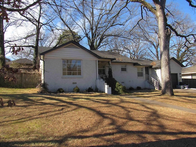 view of front of property featuring a garage and a front lawn