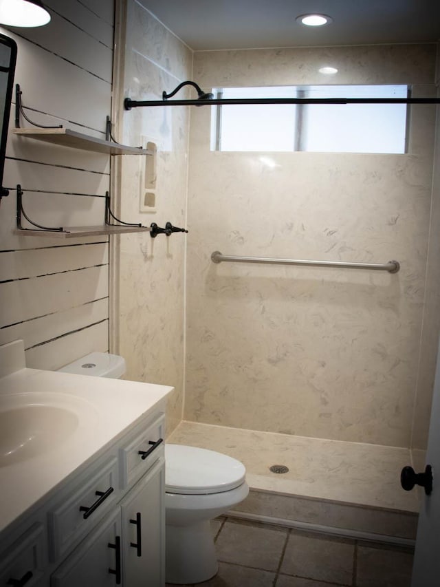 bathroom featuring toilet, vanity, and walk in shower