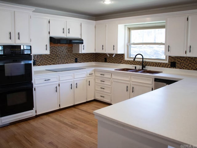 kitchen featuring sink, white cabinetry, black appliances, and range hood