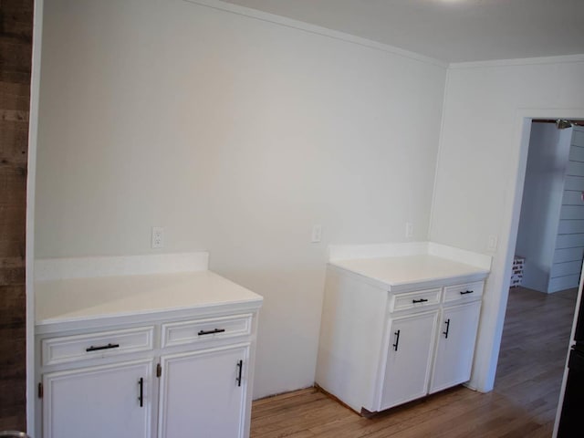 interior space with hardwood / wood-style floors and crown molding