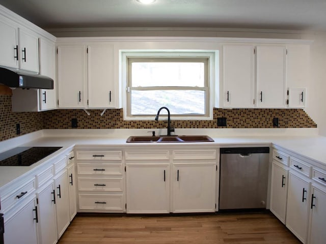 kitchen with white cabinets, exhaust hood, sink, stainless steel dishwasher, and light hardwood / wood-style flooring