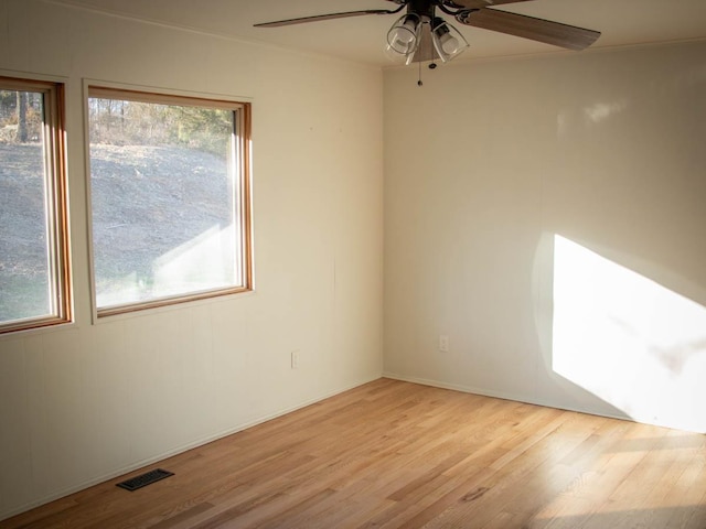 empty room with ceiling fan and light wood-type flooring